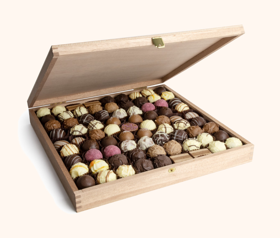 Geöffnete Holzkiste mit Pralinen von DreiMeister
